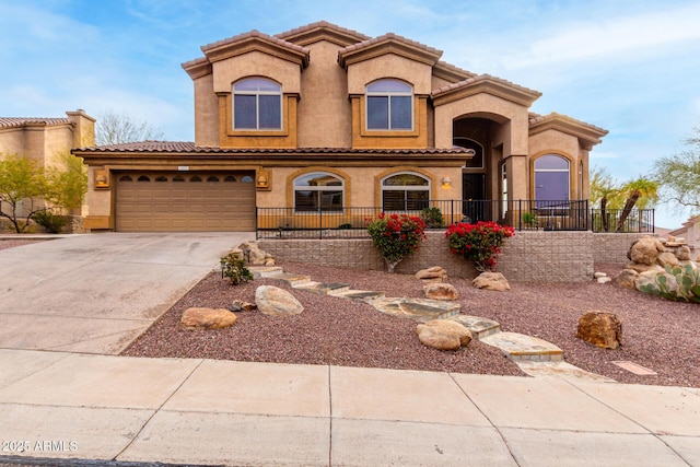 mediterranean / spanish-style home with a garage