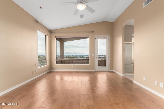 spare room featuring ceiling fan, lofted ceiling, and light hardwood / wood-style floors