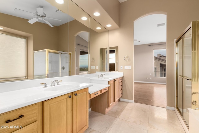 bathroom with ceiling fan, vanity, and walk in shower