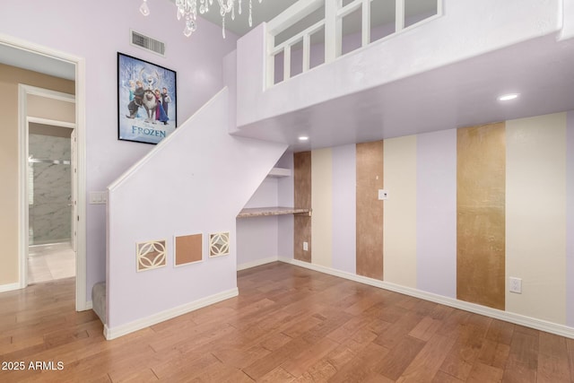 stairway featuring hardwood / wood-style floors and a high ceiling