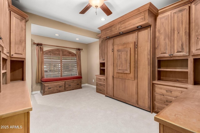 interior space with light colored carpet and ceiling fan