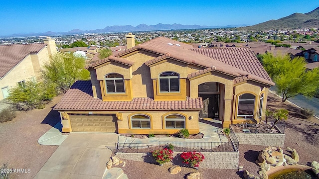 mediterranean / spanish-style home featuring a garage and a mountain view