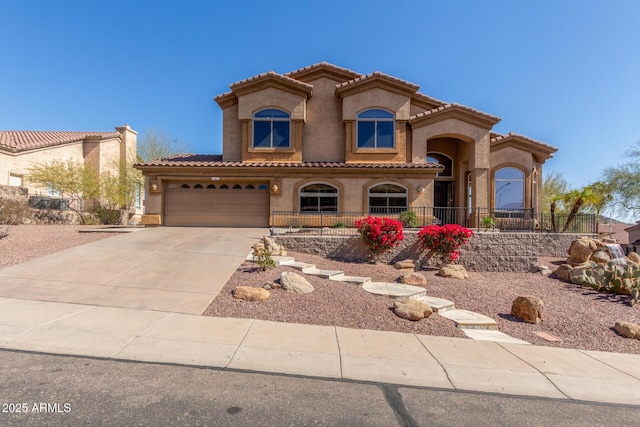 mediterranean / spanish-style house with a garage