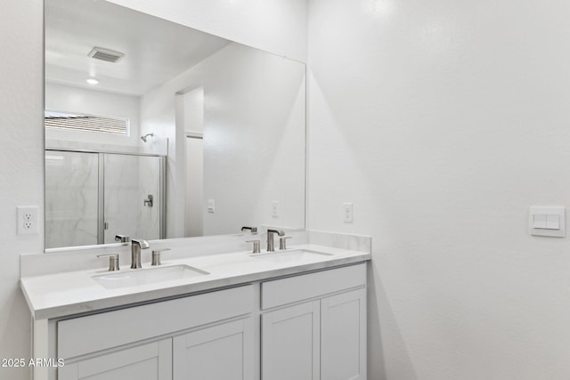 bathroom featuring vanity and a shower with door