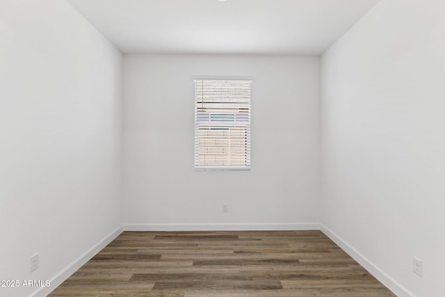 empty room featuring dark hardwood / wood-style flooring