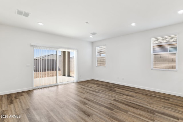 spare room with dark wood-type flooring