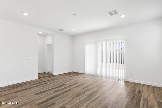 unfurnished room with dark hardwood / wood-style floors