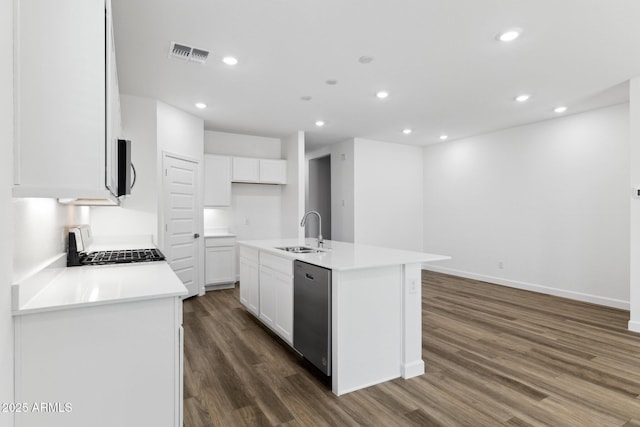 kitchen with sink, stainless steel appliances, white cabinets, a center island with sink, and dark hardwood / wood-style flooring