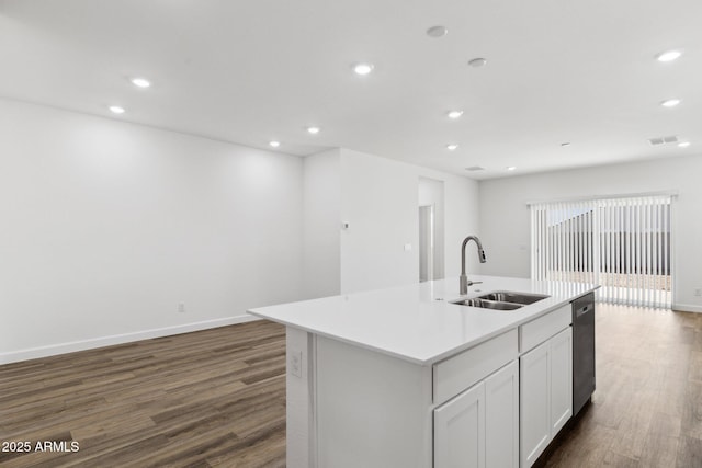 kitchen featuring dark hardwood / wood-style floors, white cabinetry, an island with sink, sink, and stainless steel dishwasher