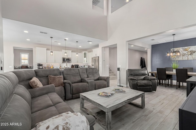 living room featuring an inviting chandelier and light hardwood / wood-style floors