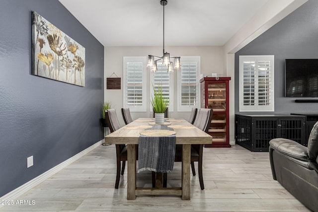 dining area with a notable chandelier and light wood-type flooring