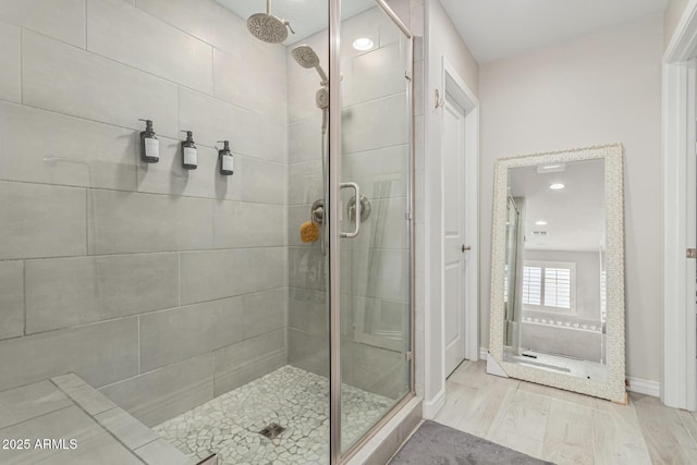 bathroom featuring wood-type flooring and walk in shower