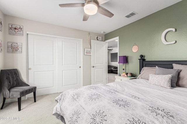 carpeted bedroom featuring ceiling fan and a closet