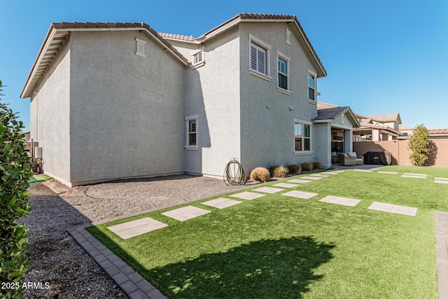 rear view of property with a yard