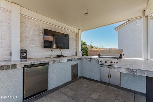 view of patio / terrace featuring grilling area, exterior kitchen, and sink