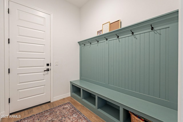 mudroom featuring wood finished floors and baseboards