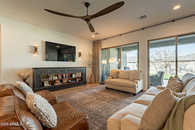 living area with ceiling fan, visible vents, wood finished floors, and recessed lighting