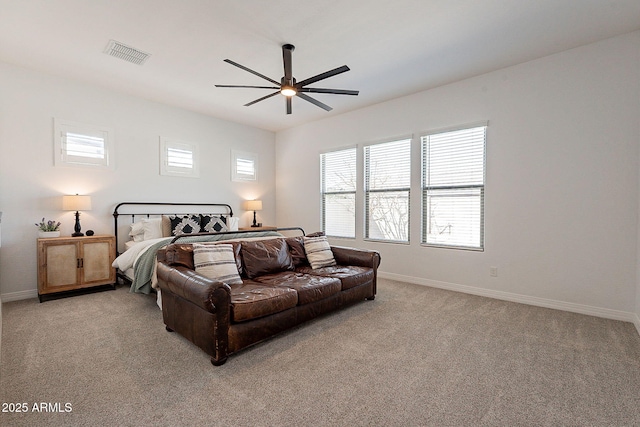 bedroom with light carpet, baseboards, visible vents, and a ceiling fan