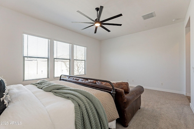 carpeted bedroom with a ceiling fan, visible vents, and baseboards