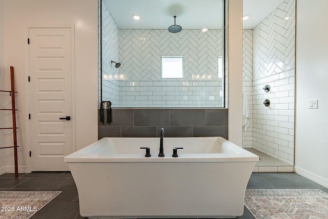 full bathroom featuring a freestanding bath, walk in shower, and tile patterned flooring