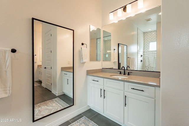 full bath featuring tile patterned flooring, visible vents, vanity, and baseboards