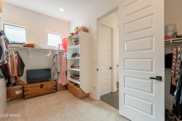 spacious closet featuring carpet and tile patterned flooring