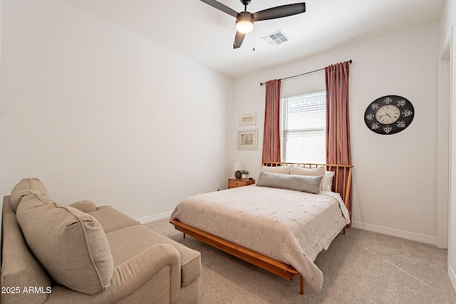 bedroom with light carpet, ceiling fan, visible vents, and baseboards