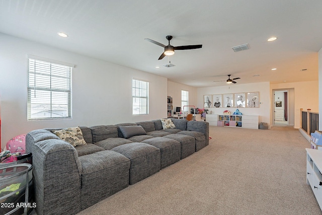 carpeted living area featuring a ceiling fan, recessed lighting, and visible vents