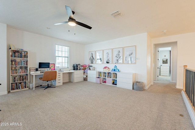 office area featuring baseboards, carpet floors, visible vents, and a ceiling fan