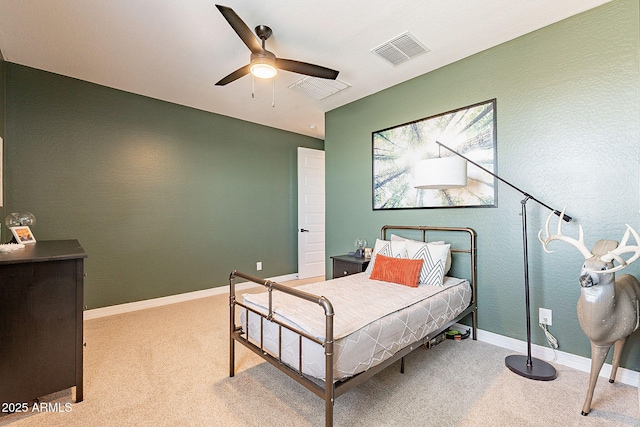 carpeted bedroom with a ceiling fan, visible vents, and baseboards