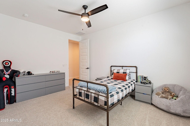 carpeted bedroom with ceiling fan and visible vents