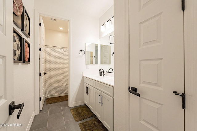 full bathroom featuring curtained shower, tile patterned flooring, visible vents, vanity, and baseboards