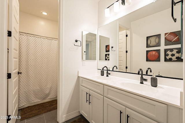 bathroom featuring double vanity, a shower with curtain, a sink, and tile patterned floors