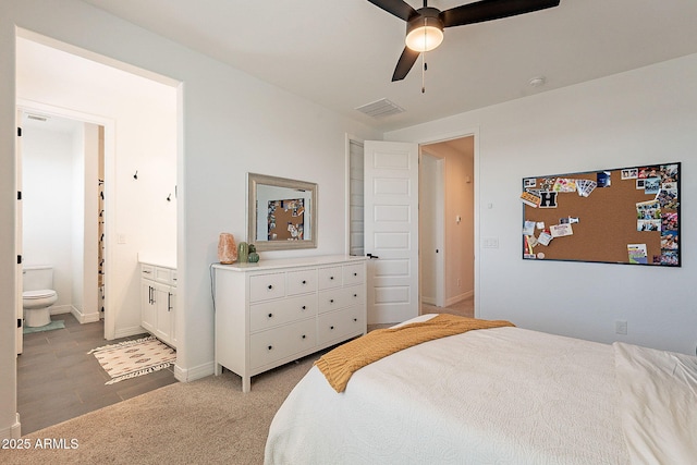 bedroom with visible vents, light carpet, connected bathroom, ceiling fan, and baseboards