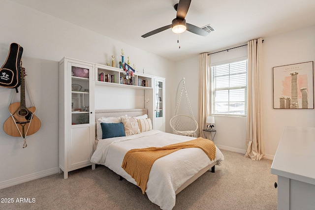 bedroom with light carpet, baseboards, visible vents, and a ceiling fan