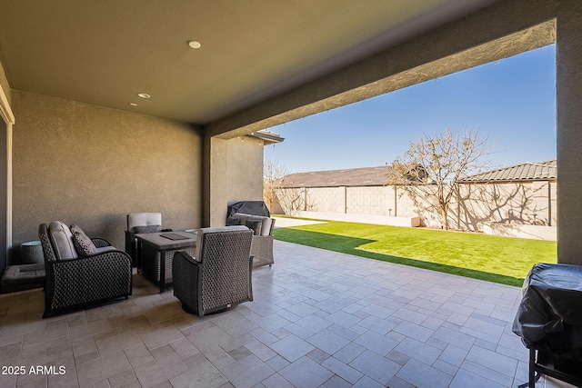 view of patio with grilling area and a fenced backyard