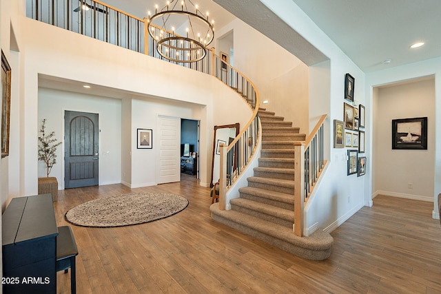 foyer featuring stairs, recessed lighting, baseboards, and hardwood / wood-style flooring