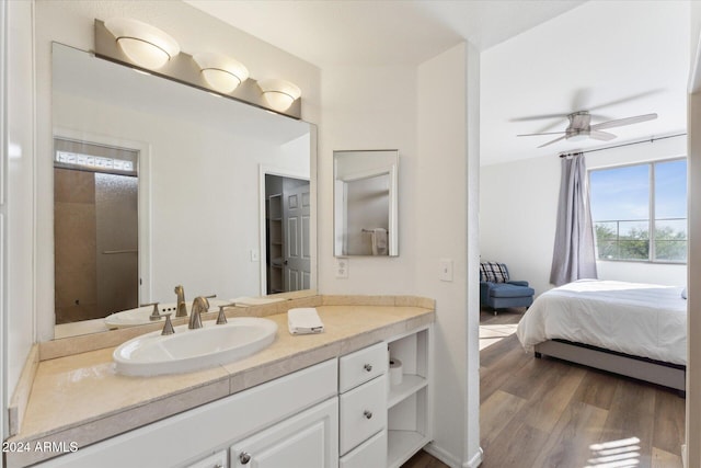 bathroom featuring ceiling fan, vanity, and wood-type flooring