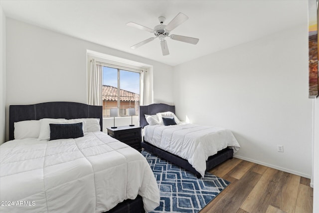 bedroom featuring ceiling fan and dark hardwood / wood-style flooring