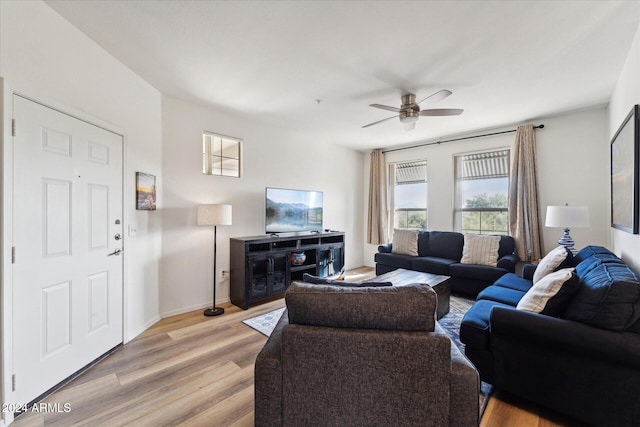 living room featuring ceiling fan and light hardwood / wood-style floors