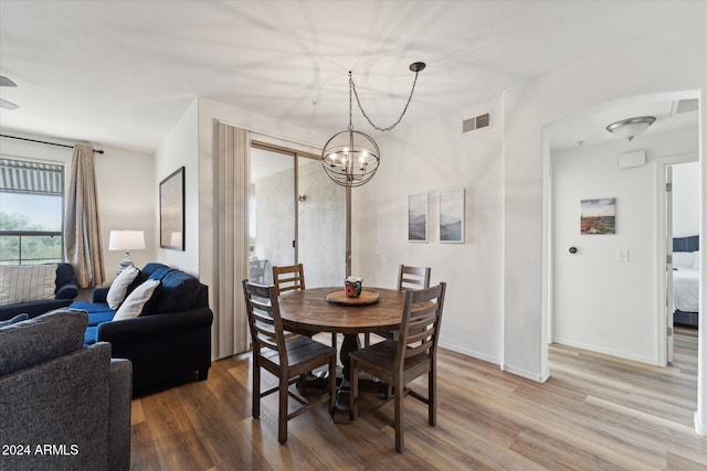 dining space featuring a notable chandelier and hardwood / wood-style flooring