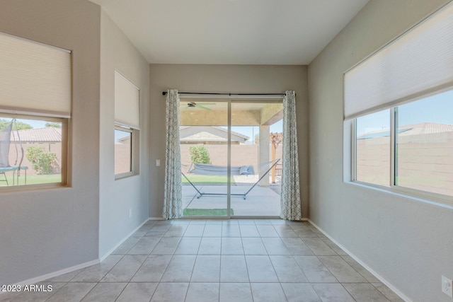 tiled spare room with a wealth of natural light