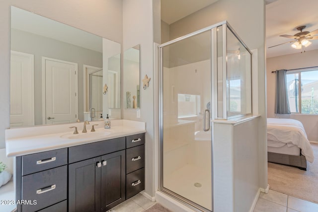 bathroom featuring tile patterned flooring, a shower with door, ceiling fan, and vanity