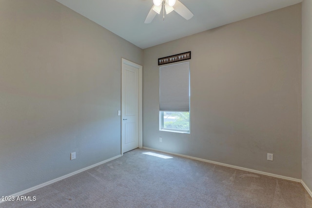 unfurnished room featuring ceiling fan and light carpet