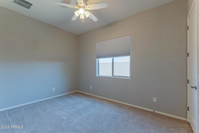 empty room featuring ceiling fan and light carpet