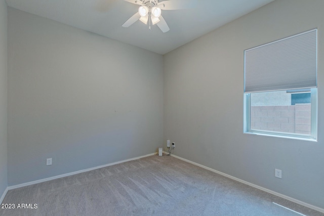 spare room with light colored carpet and ceiling fan