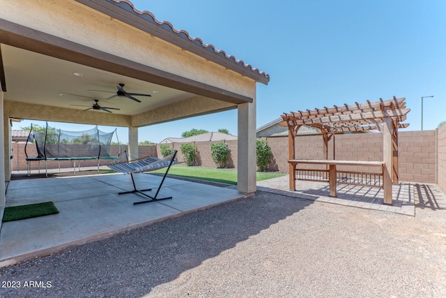 view of patio / terrace featuring ceiling fan, a pergola, and a trampoline