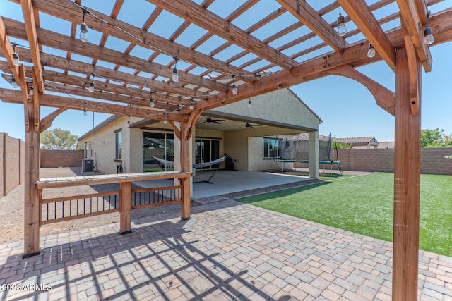 view of patio with a trampoline and a pergola