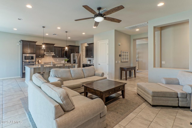 tiled living room featuring ceiling fan