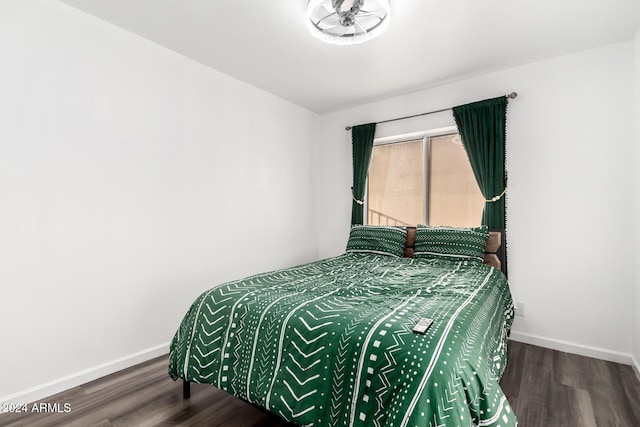 bedroom with dark hardwood / wood-style flooring